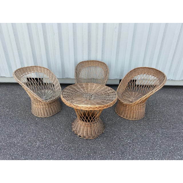 Set of three armchairs and a table from the 1970s. One armchair seat is slightly worn and some of the wood fibers are...