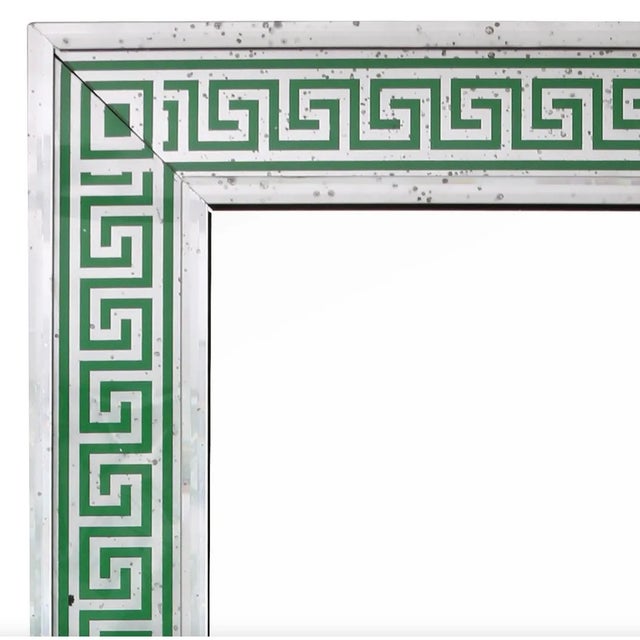 This custom oversized rectangular mirror features a striking green frame adorned with a classic Greek key pattern,...