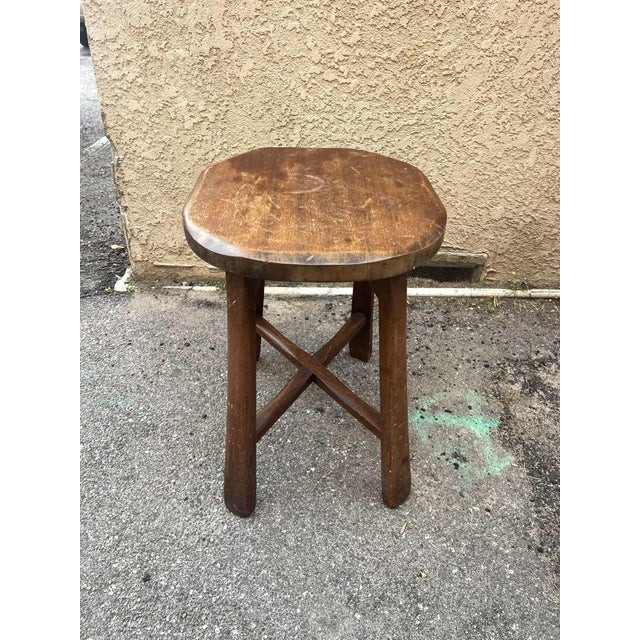 Vintage antique barn stool crafted from solid oak wood with a rich, timeworn patina. Features a thick oval seat with...