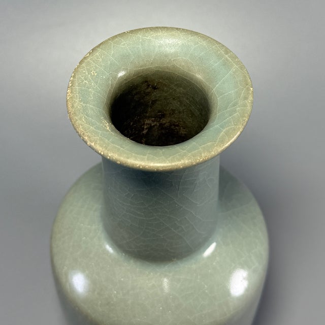 Fine antique Chinese celadon mallet‑form vase. Tall straight cylindrical neck rising upon stout squared body, covered in...