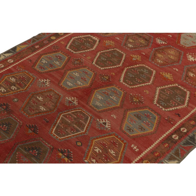 Originating between 1950-1960, a rare 8x11 vintage kilim rug believed to hail from the Sarkisla lineage of Turkey....