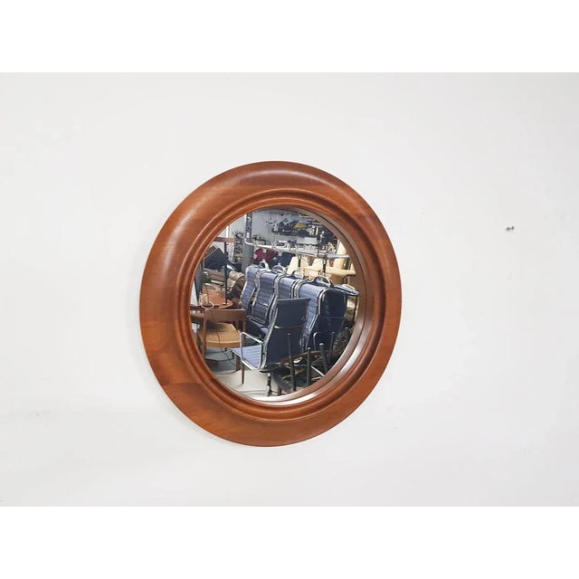 Round teak mirror, marked with made in Denmark.