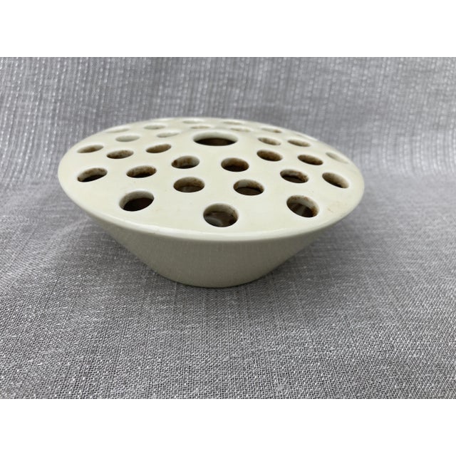 Vintage ceramic flower pin frog. No makers mark. Excellent condition. It measures 4 7/8" in diameter by 2" in height.