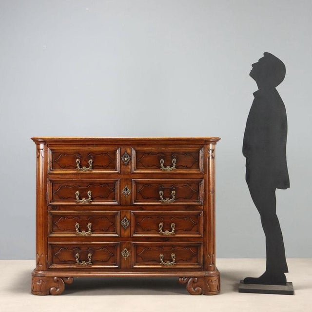 Baroque walnut canterano dating back to the early 17th century, originating from Lombardy. This imposing piece features a...