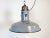 This industrial grey enamel pendant lamp was manufactured during the 1950s in former Czechoslovakia. The lamp has white...