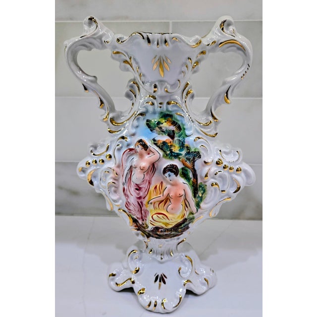 A striking mid-century Italian Capodimonte figural porcelain urn vase, finely detailed with a romantic hand-painted scene...