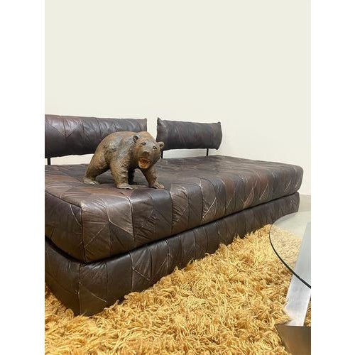 This unique vintage piece is a leather patchwork 2-seater lounge sofa, daybed, and double bed in one of a feast for the...