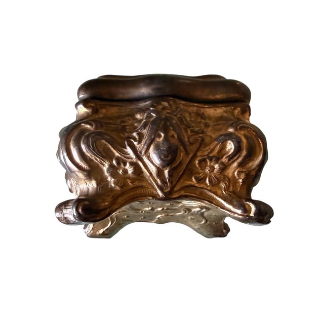 A beautifully detailed antique Art Nouveau jewelry casket featuring a sculptural bird motif on the lid surrounded by...