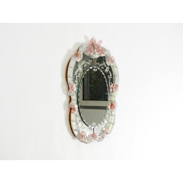 A rare and stunningly beautiful Mid-Century Modern wall mirror with an elaborate Murano glass frame. Made in Italy during...