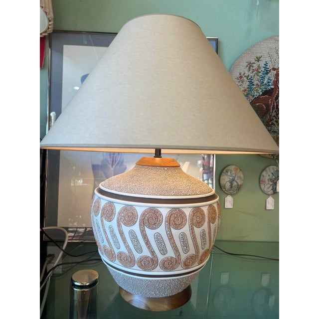 Large ball earthenware lamp with a nubby, textured finish, Southwestern/ Tiki design, and coolie shade. Has no chips,...