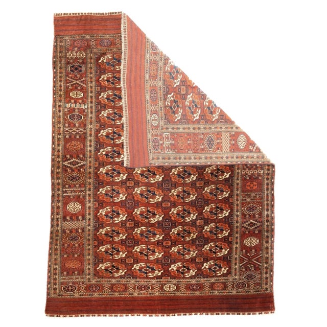 This classic Turkmenistan Tekke tribal carpet features a saturated red field with four columns each of twe3lve...
