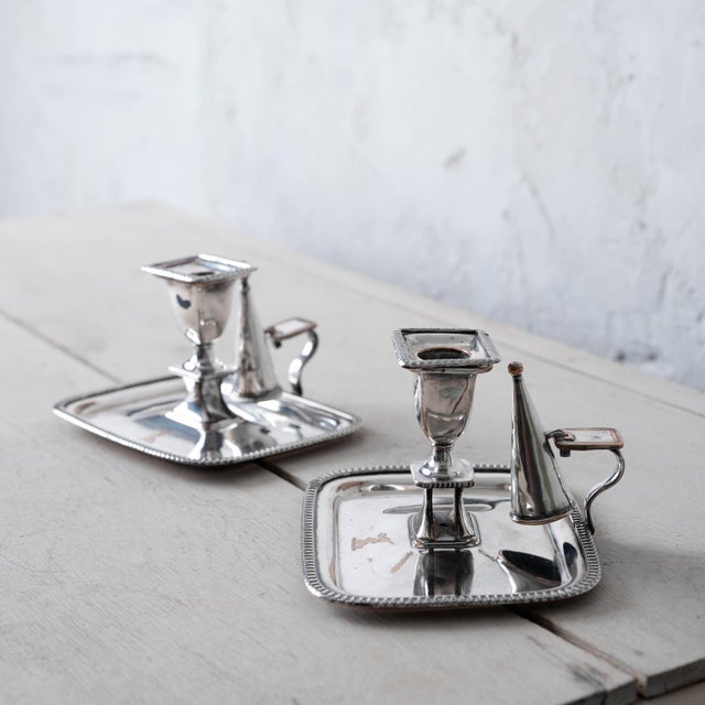 Pair of Old Sheffield plate chambersticks with removable nozzles, conical snuffers, and handled drip pans, circa 1820....