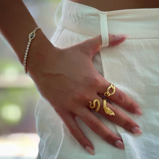 Emerald Eyed Rebirth Gold Snake Design Ring, a remarkable piece that seamlessly blends elegance, symbolism, and...