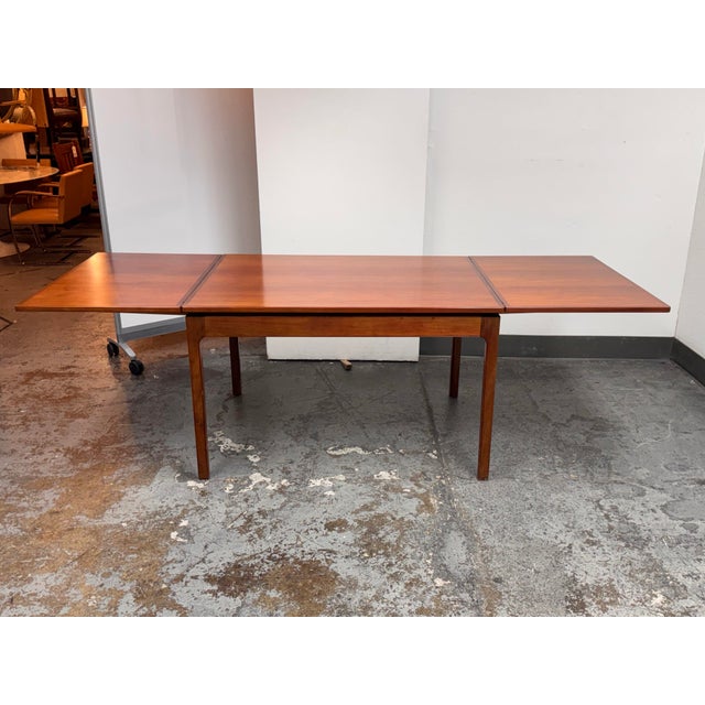 Design Plus Gallery presents a Danish Mid 20th Century Modern Wood Extension Dining Table. This Tropical Mahogany table...