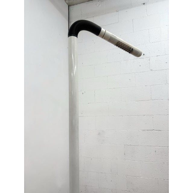 1970s Space Age floor lamp featuring a tubular steel construction, cream-colored powder-coated finish, and an articulating...