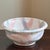 Offering a late-20th / early-21st century artisanal pottery bowl. This handcrafted bowl features a soft pastel color...