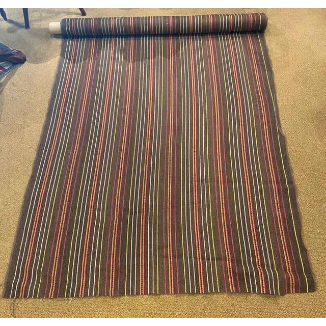 Osborne & Little's Tabriz Collection "Bukhara" woven fabric features a vertical striped pattern composed of brightly...