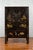 A Qing dynasty two-door elmwood cabinet from the 19th century, with original black lacquer and hand-painted decor. Created...