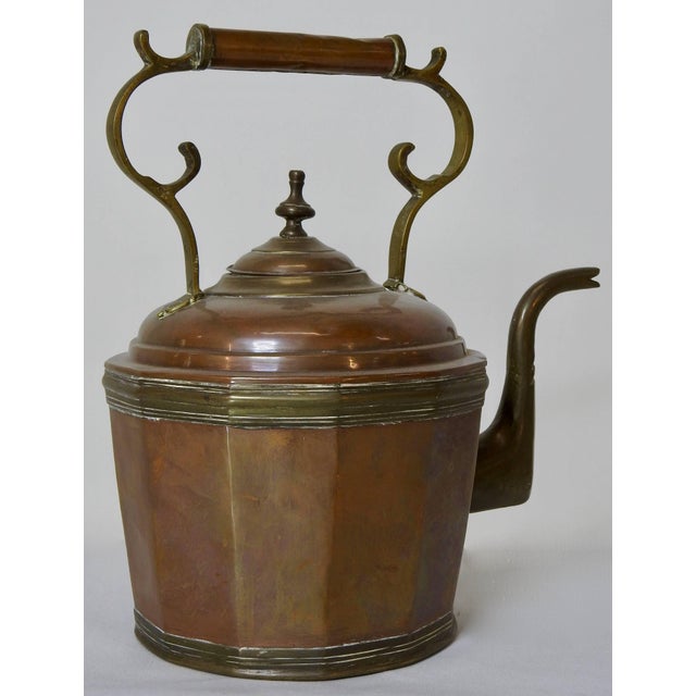 This 19th century copper and brass water pot has detailing like no other. Starting at the bottom with a beautiful brass...
