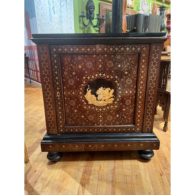 Italian, circa 1900. A fantastic rosewood veneer and ebonized hardwood cabinet. Rectangular form with later dark green...