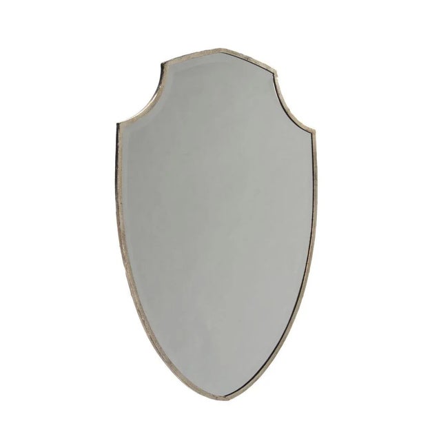 Shield shaped beveled mirror in distressed silver finish.