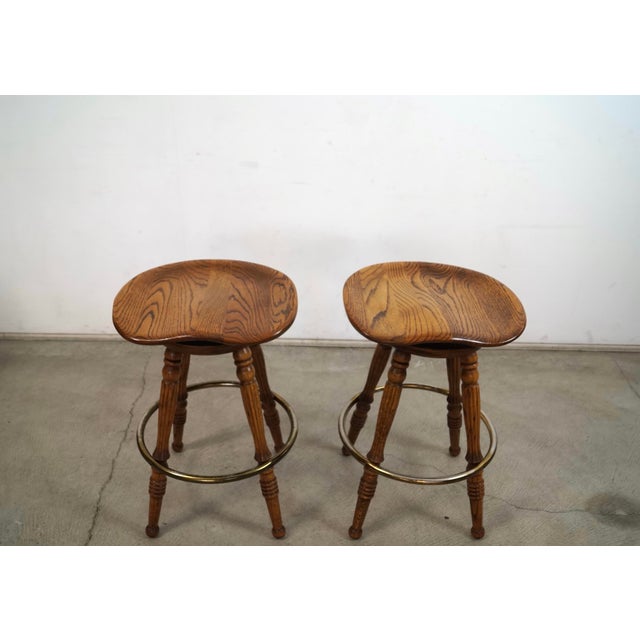 Pair of vintage 1970's solid oak saddle counter stools for sale. They were manufactured here in LA by H. W. Hull & Son,...