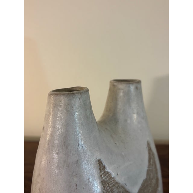 A sculptural mid-century American studio pottery double bud vase by noted ceramist Frances Simches. Hand-built with an...