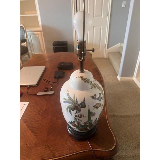 This is a vintage-style table lamp featuring a classic porcelain ginger jar base with hand-painted floral and botanical...