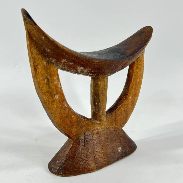 Ethiopian headrests come in various forms. They range from simple to elaborately carved artifacts. They have abstract...