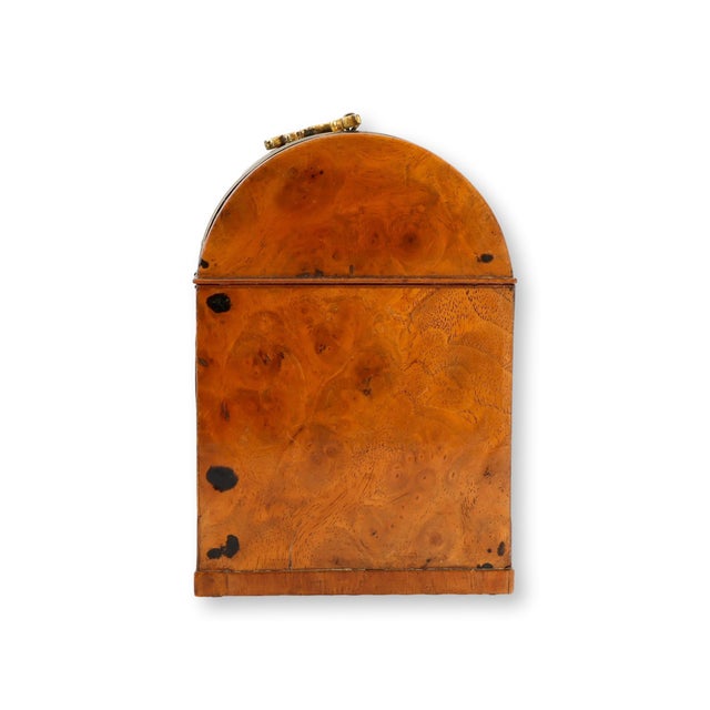 19th century English burlwood box featuring a domed lid, rich figured grain, and finely detailed polished brass mounts....