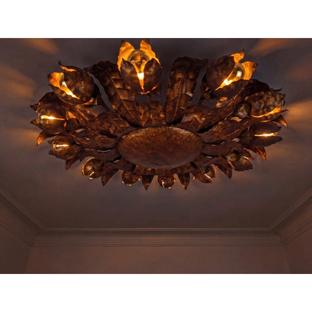 This ceiling lamp reflects the sunburst lighting designs popular in mid-century interiors, dated to the 1950s. A dense...