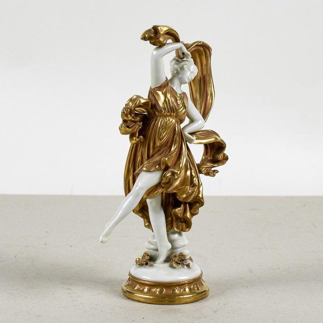 This refined capodimonte ceramic sculpture depicts a dancer in a dynamic and elegant pose, typical of mid-twentieth-...