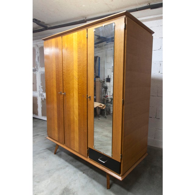 French wardrobe from the 1960s with splayed legs. it consists of a hanging section (2 doors) and a shelving section with 3...