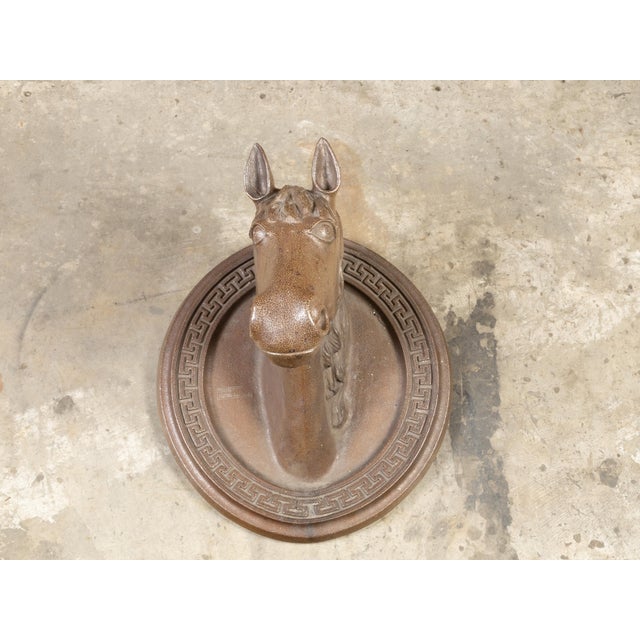 An English Victorian period terracotta horse head sculpture from the 19th century on oval backplate with Greek Key motifs....