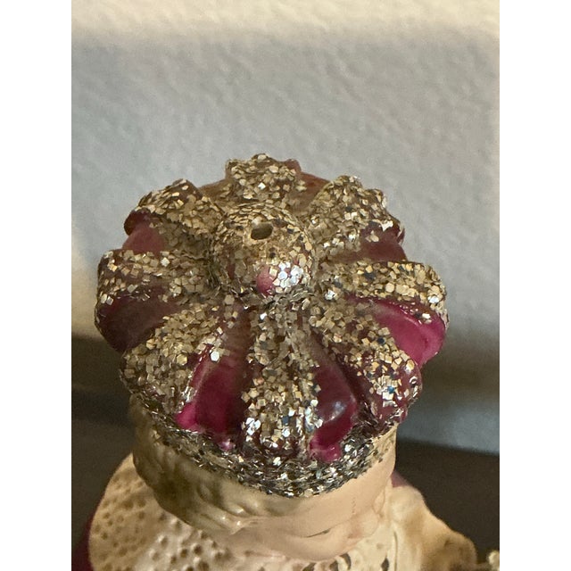 Vintage ceramic Infant Jesus of Prague figurine featuring a richly detailed crown, floral-decorated robe, and royal mantle...