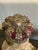 Vintage ceramic Infant Jesus of Prague figurine featuring a richly detailed crown, floral-decorated robe, and royal mantle...