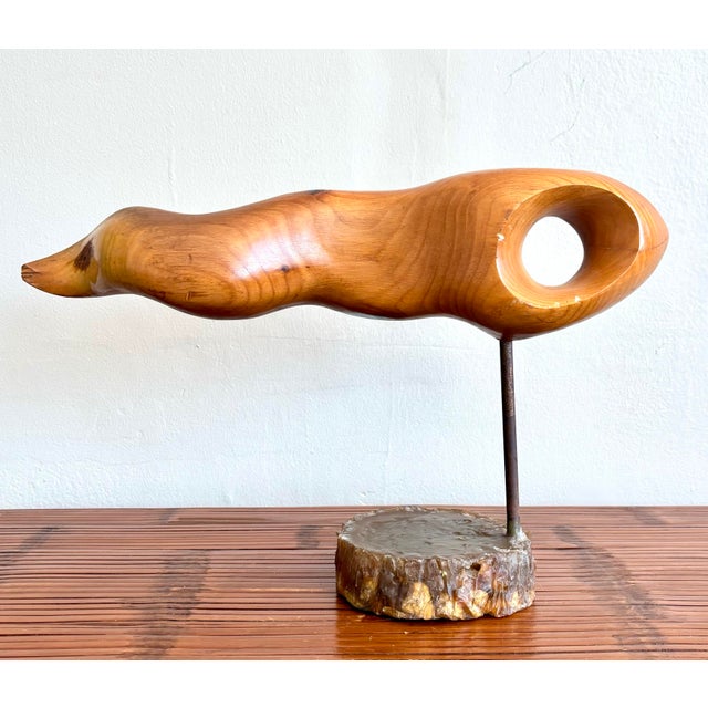 This abstract wood sculpture by James Coutant, dated 2002, is a striking example of organic minimalism. Carved from a...