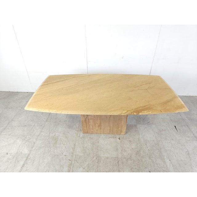 Elegant travertine dining table with a beautiful naturally veined table top with a beveled edge. Timeless piece. Sits up...