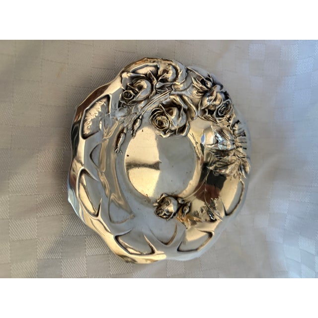 An antique sterling silver art nouveau bowl decorated wtith raised roses. The bowl is commonly used to display roses or as...