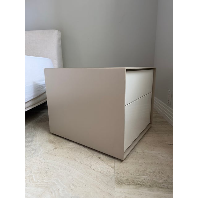 Dado bedside table. Frame is MDF wood paneling in a satin tan finish. Drawers are glossy lacquered melamine. Both...
