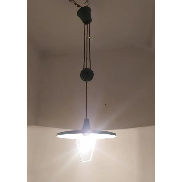 This pendant lamp Is attributed to Arredoluce for form and style. This piece is attributed to the mentioned...