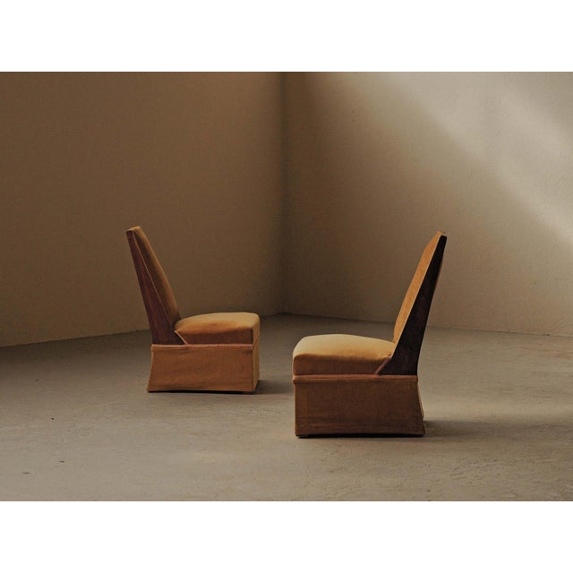 Pair of Art Deco slipper chairs dating from around 1930, with a simple structure and tall, slightly angled backs. The...