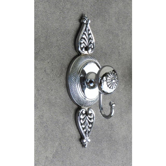 French Neoclassical Revival Style Chrome Vanity Hook Set, C1970s. Stylish French double and simple hook in chrome, with...