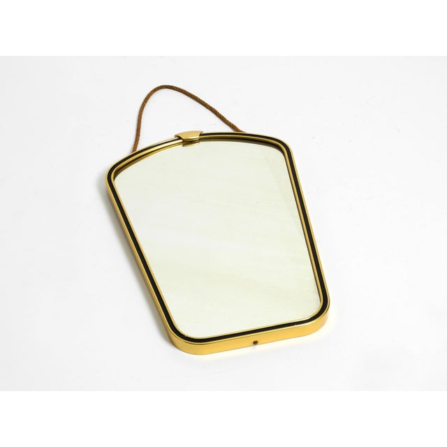 Original 1950s beautiful brass wall mirror. with original braided strap for hanging. Very high-quality craftsmanship in a...