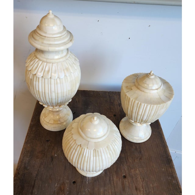 A striking, curated trio of tessellated bone covered jars. Infused with a chic Hollywood Regency flair and grounded in...
