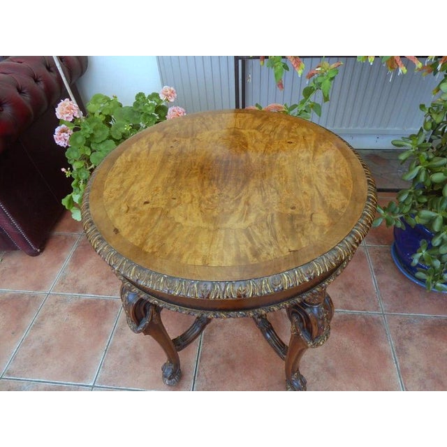Maple & Co. Walnut and Parcel-Gilt Occasional Table, circa 1920s Material: Walnut and parcel gilt A fine early 20th-...