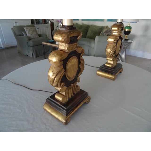 A Beautiful pair of lamps carved on both the front and the back with custom lamp shades they are newly rewired.