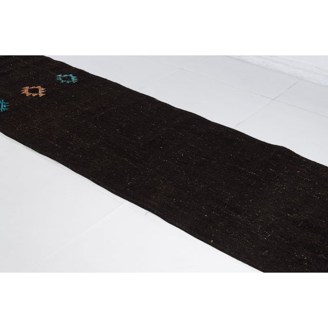 This is a vintage Turkish Oushak rug from the Mid 20th Century. The piece was hand-knotted.