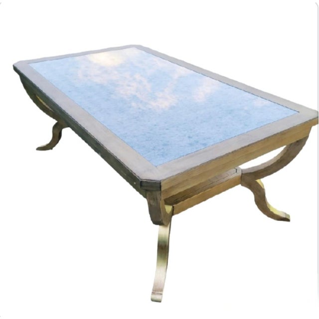 A beautiful elegant vintage coffee table by Hooker furniture. The table features a very soft silver finish with a soft...