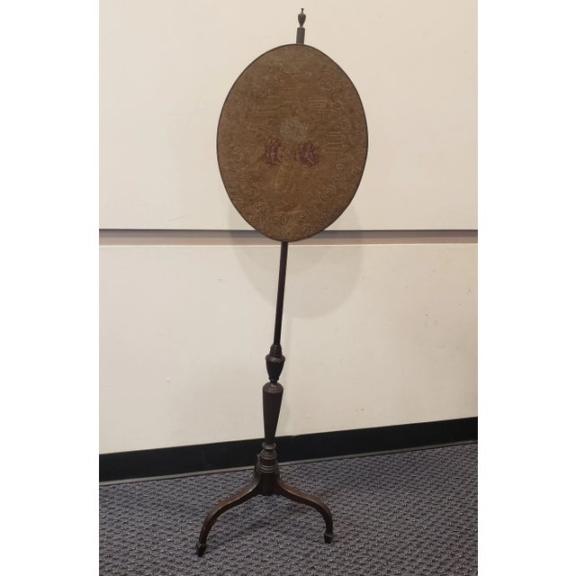 Pair of 1900s Edwardian Carved Mahogany And Needlepoint Pole Screens measuring 16" wide and 16" deep at the base, and...